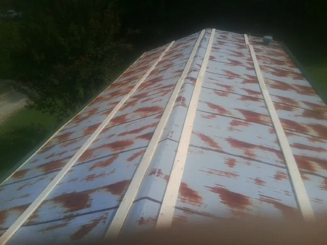Rusted metal roof panels with new wood purlins before replacement — Storm Damage Roof Repair in Danielson by Roofing Brothers