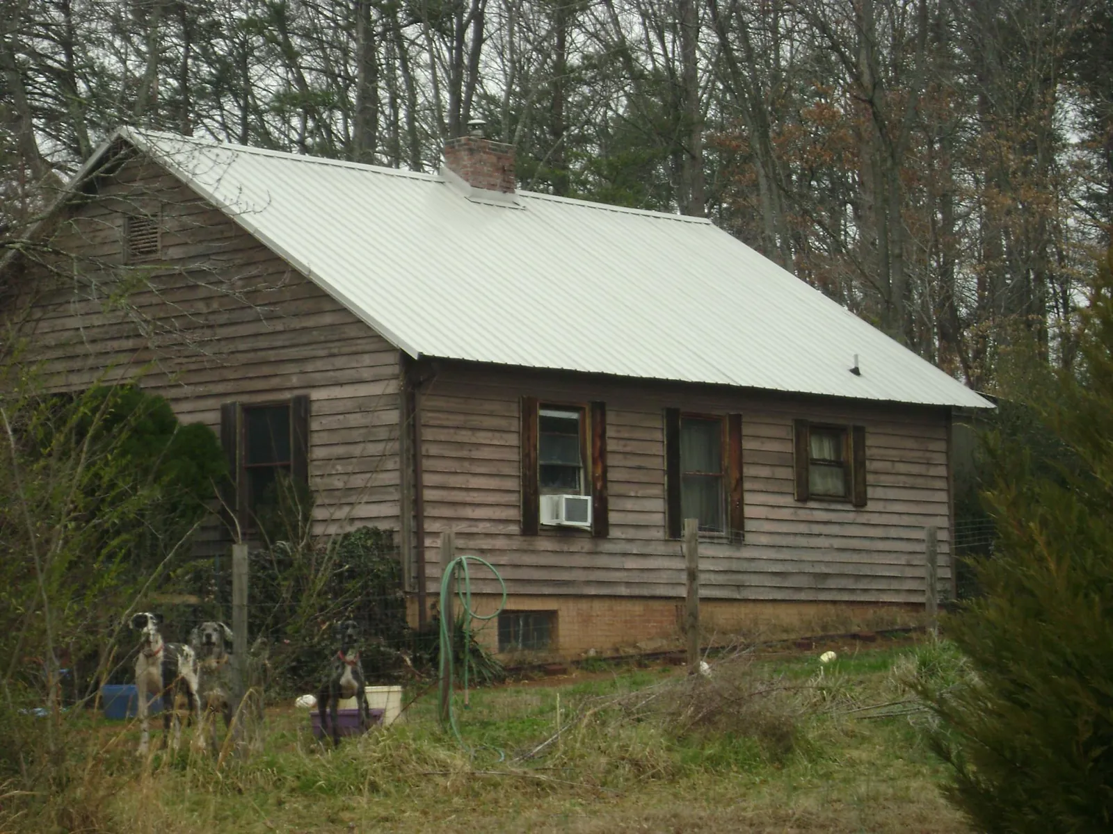 White metal roof on an old wood sided farmhouse, from a Metal Roof Installation job in Danielson